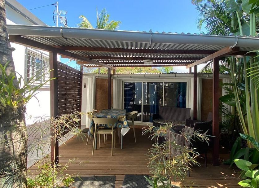 Chambres D'hotes Du Domaine Des Doudous in Saint-Pierre, covered wooden patio with dining area