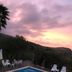 Casa Siciliana Altarbiah in Trabia: outdoor pool with lounge chairs and sunset hillside view