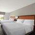 Hampton Inn and Suites Savannah-Airport guest room with two queen beds, desk, and window view in Savannah