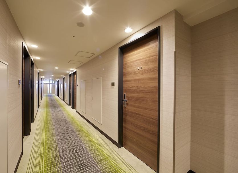 Hearton Hotel Shinsaibashi Nagahoridori in Osaka hallway with wood doors and long carpeted corridor