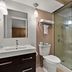 Quality Inn Wayne - Fairfield Area bathroom with vanity, toilet, and glass walk-in shower in Wayne