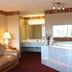 Regency Inn Richmond in Richmond: hotel room with sofa, lamp, vanity and jetted tub