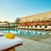 The Hollywood Grande, Autograph Collection in Los Angeles with poolside loungers and striped umbrellas