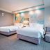 Courtyard by Marriott Toledo West guest room with two double beds and a floor lamp in Toledo