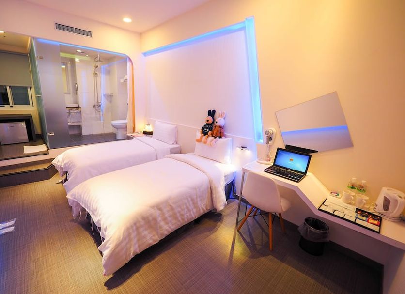Galaxia Business Hotel Taichung City guest room with two beds, desk, and colorful LED lighting