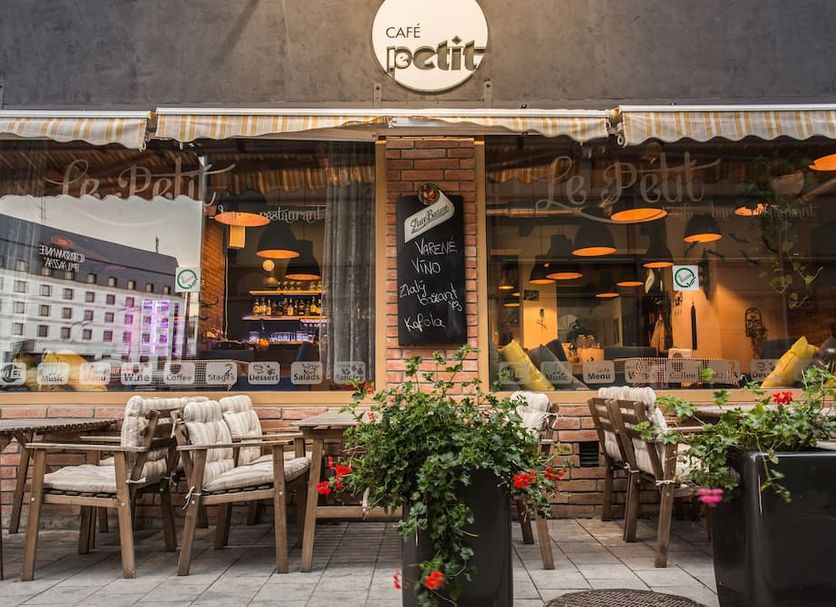 7Days B&B in Bratislava, street-side café terrace with outdoor seating and flower planters