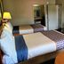 Travelodge by Wyndham Williamsburg Colonial Area guest room with two beds, TV, and closet in Williamsburg