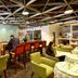 Yanjiang East Garden Inn in Guangzhou lounge with bar seating, green armchairs and café tables