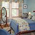 B. F. Hiestand House Bed and Breakfast in Marietta guest room with blue bed, window seat, and standing mirror