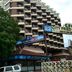 Hotel City Tower Coimbatore in Coimbatore, exterior with balconies, tree, and drive-in restaurant signage