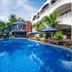 Brenta Phu Quoc Hotel in Phu Quoc with a large outdoor pool and loungers beside a white resort building