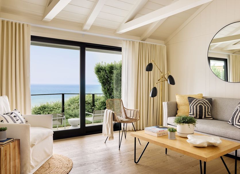 Gurney's Montauk Resort & Seawater Spa room with ocean view, balcony doors, sofa, and coffee table