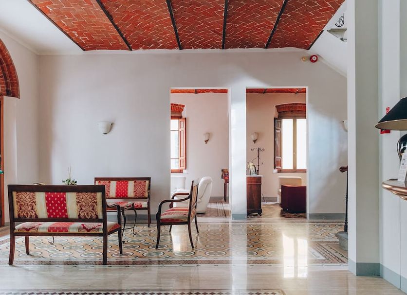 Hotel Savoia e Campana in Montecatini Terme lobby with tiled floor, arched windows and seating area