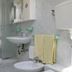 Hotel Concorde in Cesenatico bathroom with shower, sink, bidet, and wall-mounted shelves