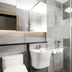 Jamsil Stay Hotel Seoul bathroom with wall-mounted sink, toilet, and glass shower enclosure