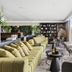 Gordonia Ma'ale Hahamisha lounge with green sofas and floor-to-ceiling windows overlooking trees