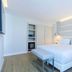 NH Monterrey La Fe guest room with king bed, bench, and modern lighting in Monterrey