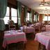 Hotel Sporting Breuil-Cervinia dining room with set tables, green curtains and wood-paneled walls