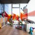 Hotel Bed4U Tudela playroom with colorful seating, kids’ toys, and children at a table in Tudela