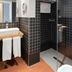 Zenit El Coloquio Valladolid bathroom with glass shower, tiled walls and sink