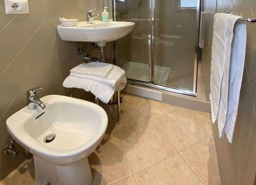 Villa Santacroce bathroom in San Giovanni Rotondo with shower stall, bidet, sink and towel rack