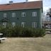 Airport Motel & Apartment in Gardermoen with green exterior and picnic table in front