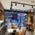 Bella Hotel in Istanbul dining area with large windows, stone wall, and track lighting