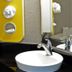 Motel 6-West Des Moines, Ia bathroom with vessel sink, chrome faucet, wall mirror and yellow shelf