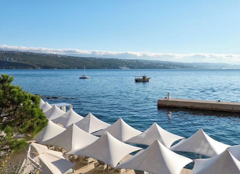 Amadria Park Hotel Royal in Opatija with white seaside terrace umbrellas and Adriatic bay views