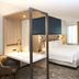 SpringHill Suites by Marriott Seattle Issaquah guest room with bed, desk, TV, and window seating
