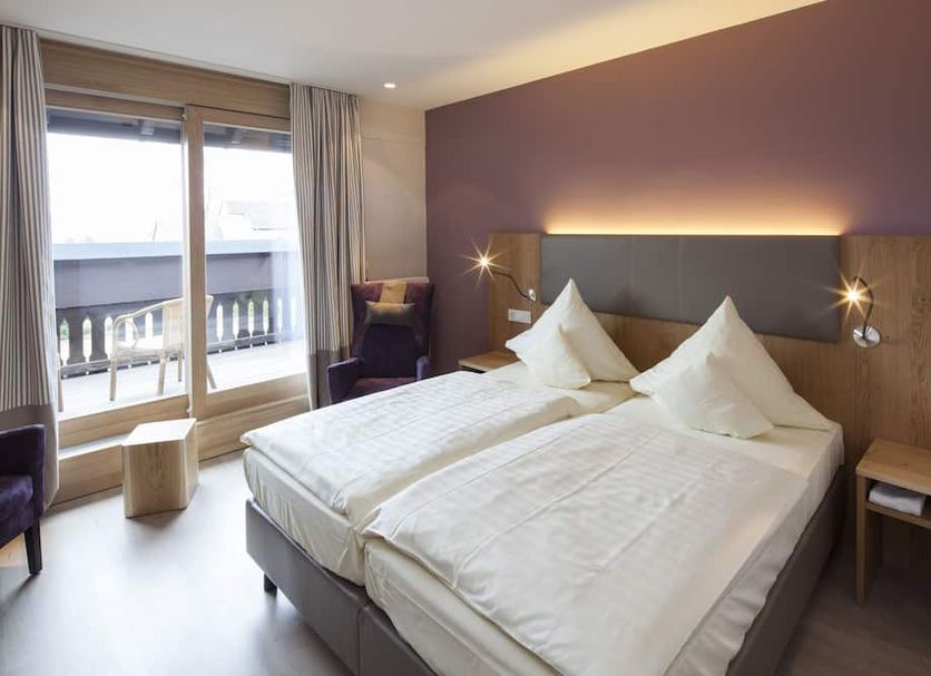 Buchnas Landhotel Saarschleife room in Mettlach with twin bed, balcony doors and outdoor view