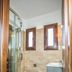 Mediterranean Holidays in Ierissós bathroom with curved glass shower, toilet and sink vanity
