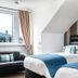Rosebank Guest House in Perth: twin beds, leather sofa and window view in a bright guest room