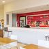 Travelodge Hull Central bar with red backlit drinks display and white counter in Hull