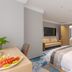 Huiwen Hotel in Shijiazhuang guest room with twin beds, sofa, wall TV, and bathroom doorway