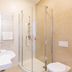 Bathroom at Osrodek Wypoczynkowy Wiga in Kolobrzeg with shower, toilet, sink and heated towel rail