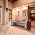 Ivory Tree Game Lodge, Pilanesberg bathroom with bathtub, double sinks and open door to bedroom