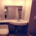 Jinjiang Inn Wuhan Wansongyuan Food Street Qushui Building bathroom with toilet, sink, mirror, and shower stall