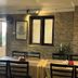 Boudha Stupa View Guest House in Kathmandu dining area with tables, chairs, and stone-accent walls