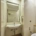 Rkn Hotel Pondicherry bathroom with sink, mirror, shower, and toilet
