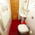 Bed and Breakfast Rosangela in Taormina bathroom with toilet, sink, towel warmer and red tile floor