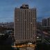 Ji Hotel Xianggang Middle Road Qingdao high-rise exterior at dusk in Qingdao city skyline