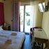 Boutique Hotel Bel Sito Wellness & Private Spa bedroom in Bardolino with twin bed, balcony door and TV