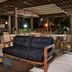 Movich Casa del Alferez in Cali, open-air terrace lounge with black sofas and dining tables