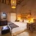 Ksar Ighnda in Aït Ben Haddou: cozy room with a king bed, woven lamps, and rustic decor