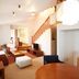 Colosseum Inn Tateshina in Tateshina guest room with loft, staircase, seating area and dining table
