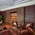The Oberoi New Delhi lounge with leather chairs, wood paneling and display shelves in New Delhi