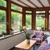 Hotel Schauinsland in Bad Peterstal-Griesbach sunroom with bay windows, armchairs and potted plants