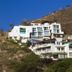 Hotel Bahia Taganga in Taganga on a hillside with white terraces and ocean-view balconies