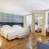 Santiago de Alfama - Boutique Hotel bedroom in Lisbon with king bed, mirrored wall and wood floors